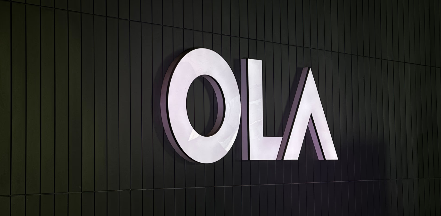 Ola Electric scooter lineup with company logo and EV manufacturing facility