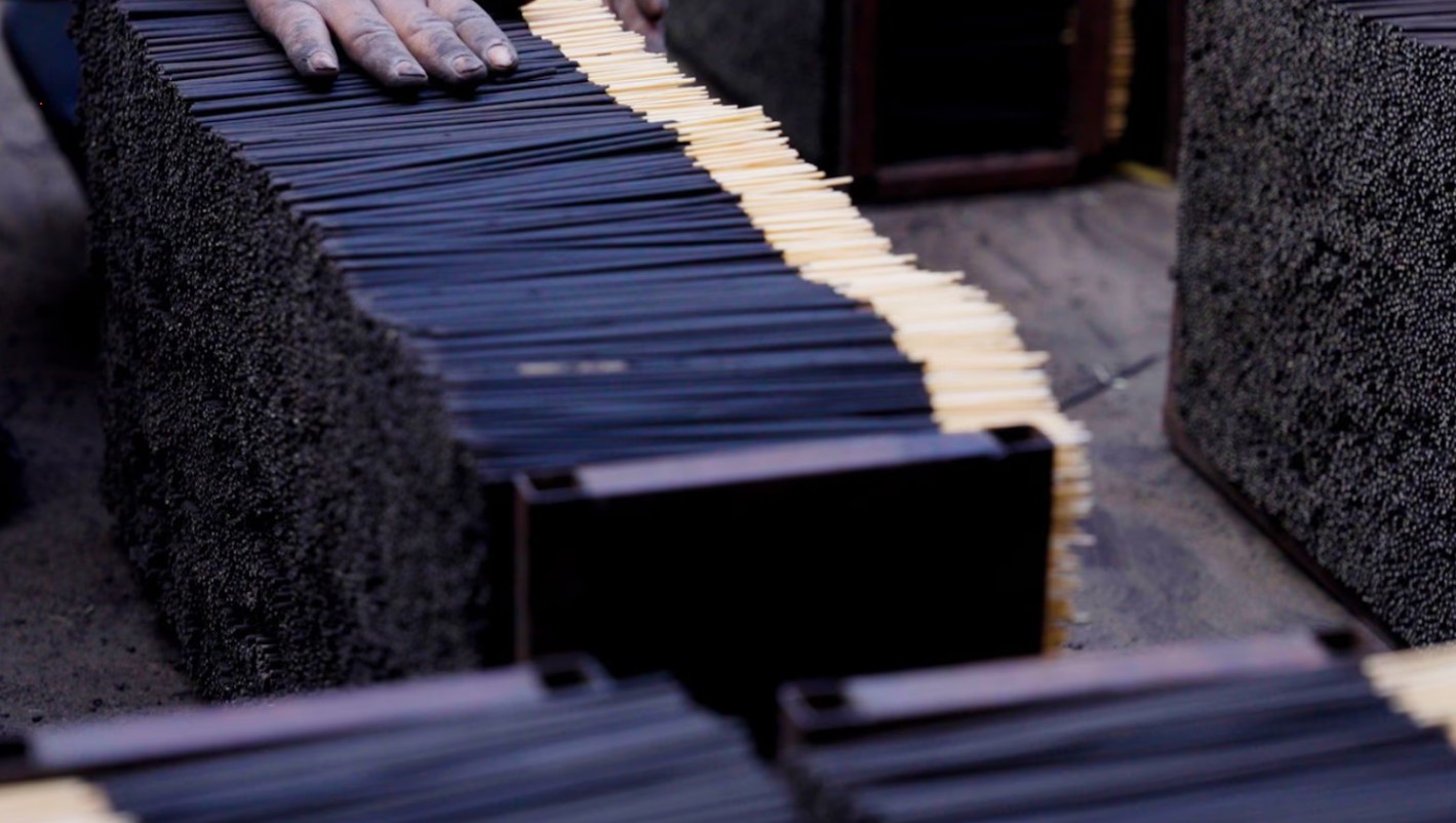 Workers producing agarbatti incense sticks in Kannauj manufacturing unit